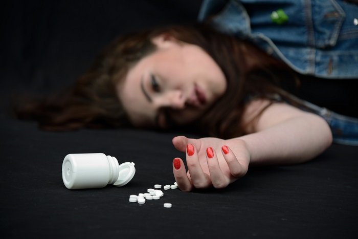 lying girl with medicine in the floor