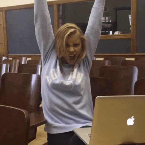 a girl raising her hands up for nailing the test